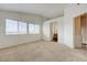 Bedroom with neutral carpet and a view into the adjacent bathroom, offering convenience and privacy at 7528 Golden Yucca Dr, Las Vegas, NV 89147