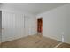 Bedroom with neutral carpet, sliding door closet, and doorway into another room at 7528 Golden Yucca Dr, Las Vegas, NV 89147