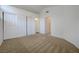Bedroom features a closet with sliding doors, neutral carpet, and a view into another room at 7528 Golden Yucca Dr, Las Vegas, NV 89147
