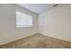 This bedroom features a neutral carpet, a window with blinds, and a closet door at 7528 Golden Yucca Dr, Las Vegas, NV 89147