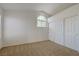 Bedroom with neutral carpet, double sliding door closet, and a large arched window at 7528 Golden Yucca Dr, Las Vegas, NV 89147