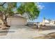 Lovely single-story home with two-car garage and desert landscaping with a mature shade tree at 7528 Golden Yucca Dr, Las Vegas, NV 89147
