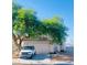 Charming single-story home with a well-maintained front yard and a large shade tree at 7528 Golden Yucca Dr, Las Vegas, NV 89147