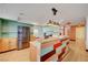 Open concept kitchen with stainless appliances, wood cabinets, and colorful accents at 7528 Golden Yucca Dr, Las Vegas, NV 89147