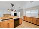 Bright kitchen features wood cabinets, stone countertops, and stainless steel appliances at 7528 Golden Yucca Dr, Las Vegas, NV 89147