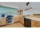 Modern kitchen with stainless appliances, light wood cabinets, and quartz countertops at 7528 Golden Yucca Dr, Las Vegas, NV 89147