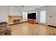 Cozy living room featuring a rustic fireplace, modern floors, and natural light at 7528 Golden Yucca Dr, Las Vegas, NV 89147