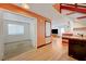 Open layout with living room, light floors, and wet bar beneath the staircase at 7528 Golden Yucca Dr, Las Vegas, NV 89147