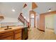 Wet bar area features wood counters, cabinetry, and mini fridge located under stairs at 7528 Golden Yucca Dr, Las Vegas, NV 89147