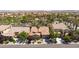 This aerial view captures the community with tiled roofs, green trees, and landscaping at 7609 Slide Rock Ave, Las Vegas, NV 89113