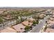 This aerial view captures the community with tiled roofs, green trees, and desert landscaping at 7609 Slide Rock Ave, Las Vegas, NV 89113