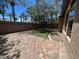 Backyard with a brick patio, desert landscaping, and a block wall for privacy at 7609 Slide Rock Ave, Las Vegas, NV 89113