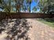 Backyard with a brick patio, trees, and a block wall for privacy at 7609 Slide Rock Ave, Las Vegas, NV 89113