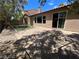 Backyard with a brick patio, desert landscaping, a block wall, windows, and a sliding glass door at 7609 Slide Rock Ave, Las Vegas, NV 89113