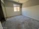 This bedroom has neutral walls, carpet, and a closet with sliding mirrored doors at 7609 Slide Rock Ave, Las Vegas, NV 89113