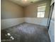 Bedroom with neutral walls, carpet, wainscotting and a closet with sliding mirrored doors at 7609 Slide Rock Ave, Las Vegas, NV 89113