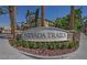 Nevada Trails community sign with lush landscaping, with multi-story homes in the background at 7609 Slide Rock Ave, Las Vegas, NV 89113
