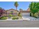 Charming single-story home with a two-car garage, neutral paint, desert landscaping, and a red tile roof at 7609 Slide Rock Ave, Las Vegas, NV 89113