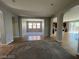 Open concept living area with tile and carpet floors, neutral paint, and arched doorways at 7609 Slide Rock Ave, Las Vegas, NV 89113