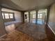 Open concept living area with tile and carpet floors, neutral paint, and arched doorways at 7609 Slide Rock Ave, Las Vegas, NV 89113