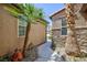 Walkway flanked by stucco and stone walls and desert landscaping at 7609 Slide Rock Ave, Las Vegas, NV 89113