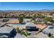 Expansive aerial view of a home with a private pool, set against a backdrop of suburban landscape and distant mountains at 7736 Tioga Ridge Ct, Las Vegas, NV 89117