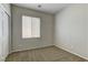 This bedroom has neutral carpeting, window and a closet with sliding doors at 7919 Dexter Falls St, Las Vegas, NV 89149