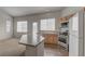 Bright kitchen with an island, stainless steel appliances, and ample cabinet space at 7919 Dexter Falls St, Las Vegas, NV 89149