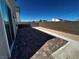 Private backyard with brick paved patio and rock landscaping under bright blue sky at 8020 Texas Hills St, Las Vegas, NV 89113