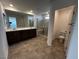 Modern bathroom with double vanity, glass enclosed shower, and tile flooring at 8020 Texas Hills St, Las Vegas, NV 89113