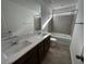 Bathroom featuring double sinks, quartz countertop, tile flooring and a shower-tub combination at 8020 Texas Hills St, Las Vegas, NV 89113