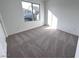 Bright bedroom featuring neutral carpet, white walls, and a large window that provides outdoor views at 8020 Texas Hills St, Las Vegas, NV 89113