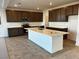 Modern kitchen with large central island, dark cabinets, and stainless-steel appliances at 8020 Texas Hills St, Las Vegas, NV 89113