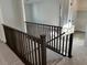 Carpeted staircase with dark wood railing leading to the upper level of the home at 8020 Texas Hills St, Las Vegas, NV 89113
