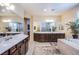 Spacious bathroom featuring double vanities, soaking tub, and separate shower in neutral color palette at 8298 W Agate Ave, Las Vegas, NV 89113
