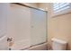 Bright bathroom features a tiled shower-tub combination and a toilet at 8298 W Agate Ave, Las Vegas, NV 89113