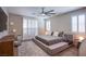 Cozy bedroom featuring a platform bed, plush rug, plantation shutters, and ample natural light at 8298 W Agate Ave, Las Vegas, NV 89113