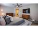 Comfortable bedroom showcasing a modern bed, hardwood floors, and stylish furniture with mounted TV at 8298 W Agate Ave, Las Vegas, NV 89113