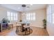 Dining area with contemporary lighting fixture and plantation shutters on the surrounding windows at 8298 W Agate Ave, Las Vegas, NV 89113