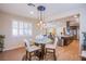 Dining space open to kitchen and living room features a modern chandelier and natural light at 8298 W Agate Ave, Las Vegas, NV 89113