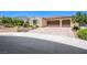 Inviting single-story home with a two-car garage, complemented by a brick-paved driveway at 8298 W Agate Ave, Las Vegas, NV 89113