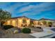 Charming home with beautiful lighting, desert landscaping, and a two-car garage at 8298 W Agate Ave, Las Vegas, NV 89113