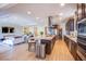 Open-concept kitchen with a large island, stainless steel appliances, and hardwood floors at 8298 W Agate Ave, Las Vegas, NV 89113