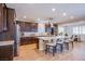 Modern kitchen featuring stainless steel appliances, a large island, and dark wood cabinets at 8298 W Agate Ave, Las Vegas, NV 89113