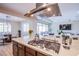 Bright, open kitchen with island cooktop, stainless steel hood, and open floor plan to dining and living areas at 8298 W Agate Ave, Las Vegas, NV 89113