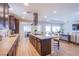 Spacious kitchen featuring an island with cooktop, stainless hood, and views into the adjacent living areas at 8298 W Agate Ave, Las Vegas, NV 89113