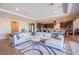 Spacious living room featuring an open layout, plush sectional sofa, and stylish modern decor adjacent to kitchen at 8298 W Agate Ave, Las Vegas, NV 89113