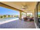 Covered patio with ceiling fans and comfortable seating, offering views of the pool at 8298 W Agate Ave, Las Vegas, NV 89113