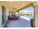 Covered patio area with outdoor furniture overlooking a pool and landscaped backyard at 8298 W Agate Ave, Las Vegas, NV 89113
