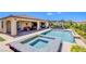 Inviting backyard featuring a pristine pool, spa, and covered patio with ample seating for outdoor relaxation at 8298 W Agate Ave, Las Vegas, NV 89113